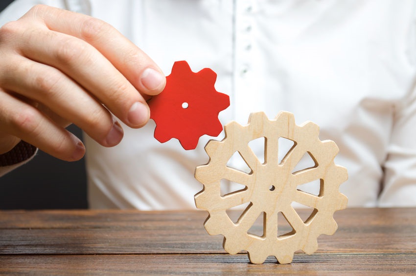 Businessman Connects A Small Red Gear To A Large Gear Wheel Symbolism Of Establishing Business Processes And Communication Increase Efficiency And Productivity The Best Business Formula For Success