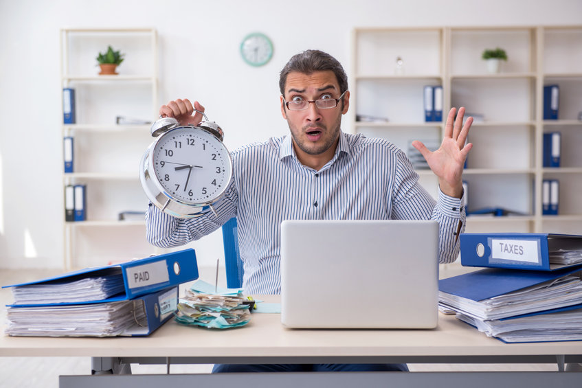 Young Male Bookkeeper In Time Management Concept