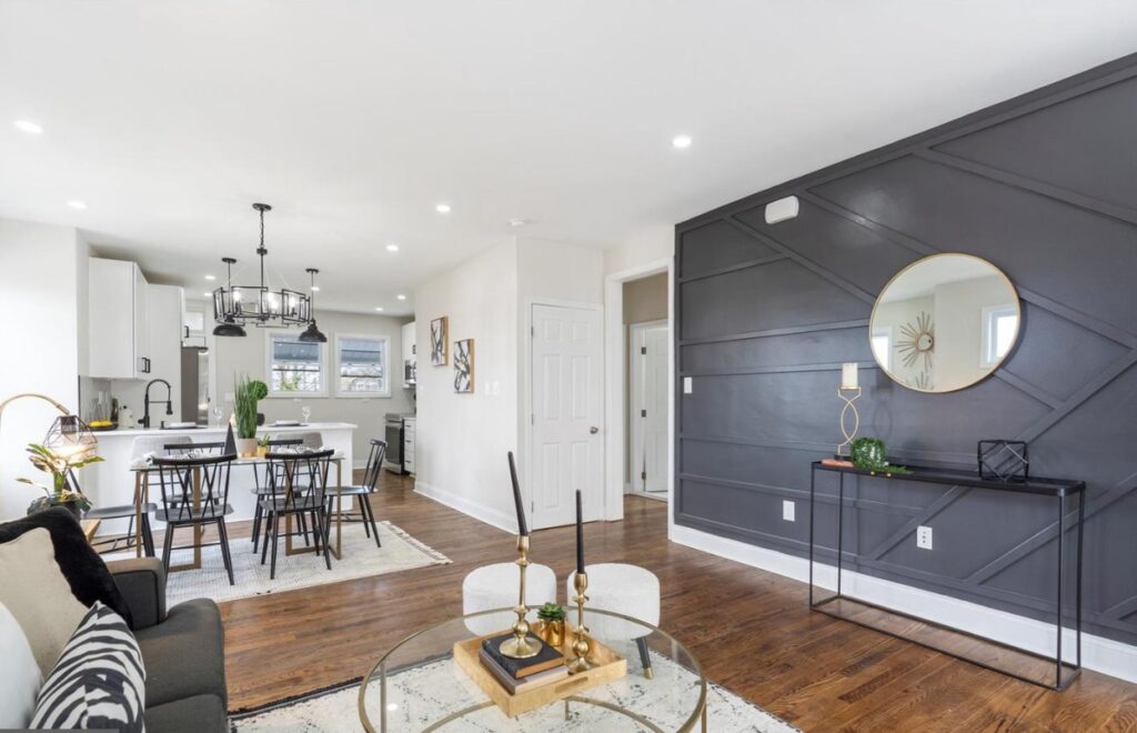 The picture of the family room with the signature black wall