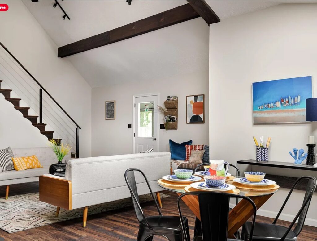 A photo of the new white dining area with dark wood beams