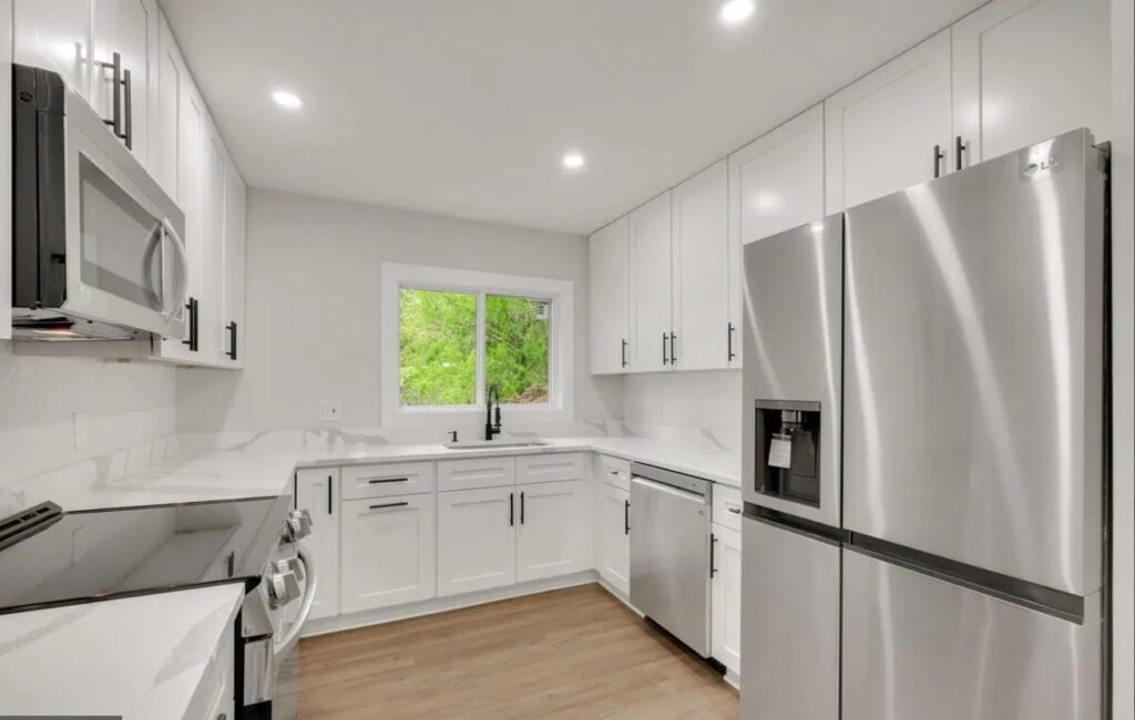 A new white kitchen with stainless steel appliances