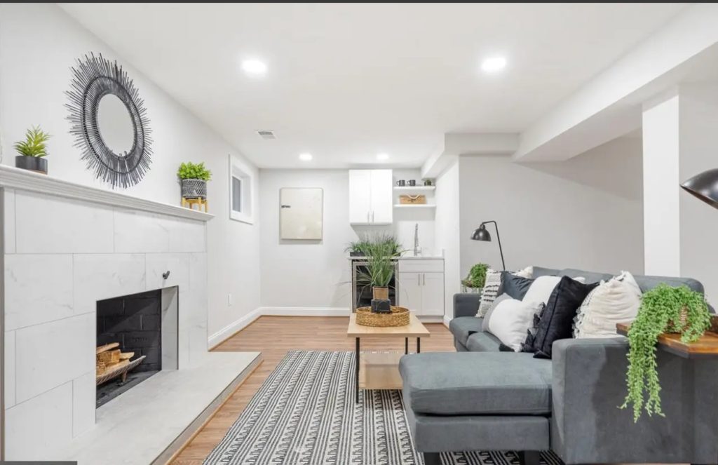 Basement view with the cozy grey couch